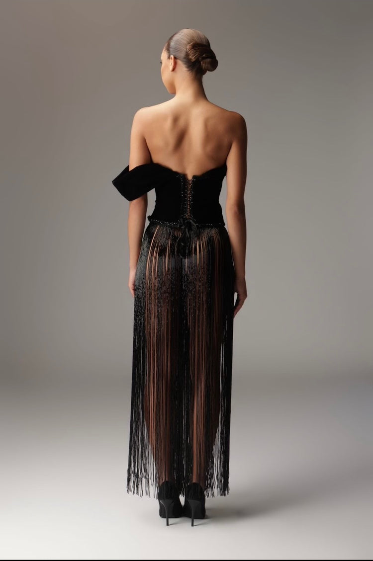 Silver crystal-embellished Ann Luchadé gown with a long train on a curved staircase