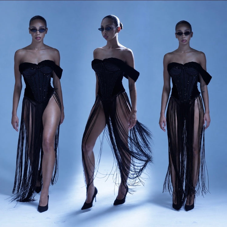 Runway lineup of models in Ann Luchadé red, silver and black evening looks